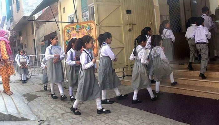 This representational image shows students going to school for the first day after summer vacation. — APP/File