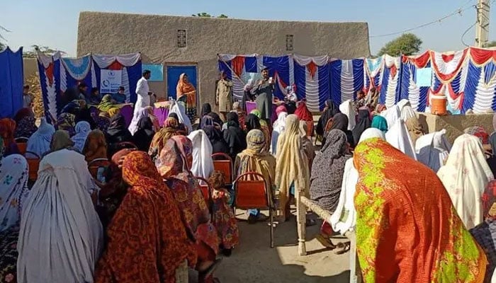 This representational image shows a ration package distribution ceremony. — ReliefWeb website/File