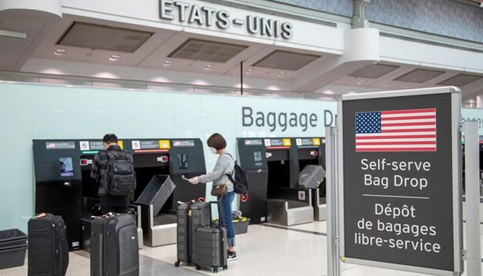 Passengers drop their bags off before walking towards the gates for U.S. travel at Toronto Pearson International Airport in Toronto, Ontario, Canada June 23, 2020. — Reuters