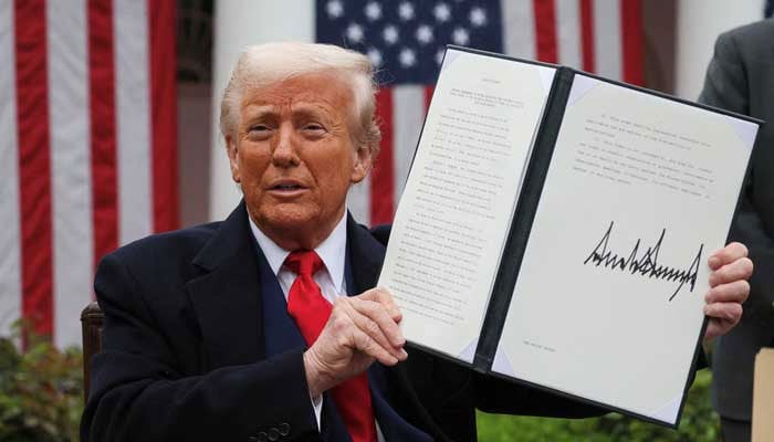 US President Donald Trump holds a signed executive order on tariffs, in the Rose Garden at the White House in Washington, DC, US, April 2, 2025. — Reuters