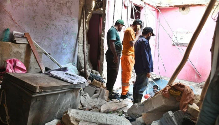 Rescue workers recover a body from the rubble of an apartment building following a gas explosion in Soldier Bazaar on February 19, 2026. — APP
