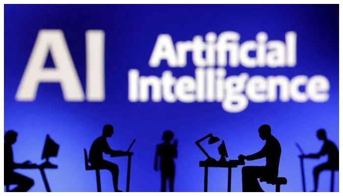 Figurines with computers and smartphones are seen in front of the words Artificial Intelligence (AI) in this illustration taken, February 19, 2024. —Reuters