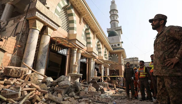 An Army soldier and rescue workers survey the damage, after a suicide blast in a mosque in Peshawar, Pakistan, January 31, 2023. — Reuters