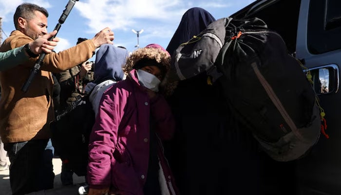 Members of Australian families believed to be linked to the Islamic State militants leave Roj camp near Derik, Syria.—Reuters