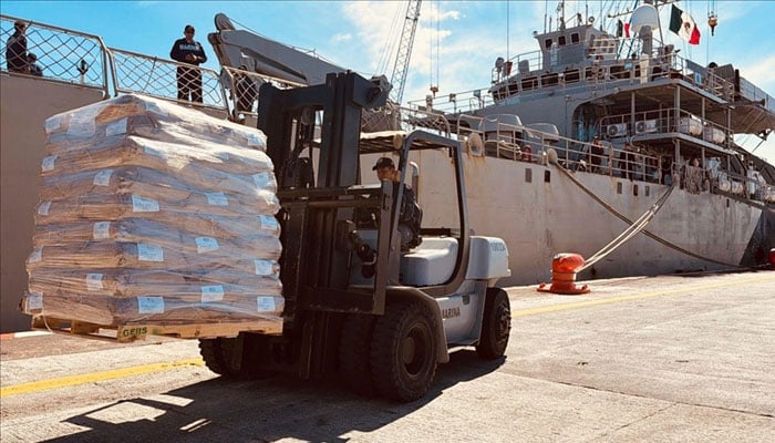 A crane carrying goods. —Anadolu Agency/File