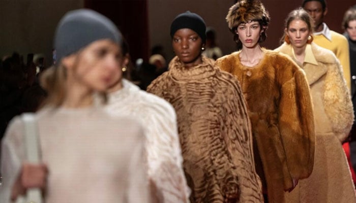 Models walking on the ramp. —AFP/File