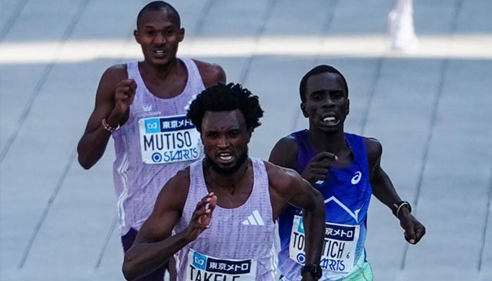 Ethiopias Tadese Takele (Centre) is running to win the Tokyo Marathon on Sunday after a sprint finish. —AFP