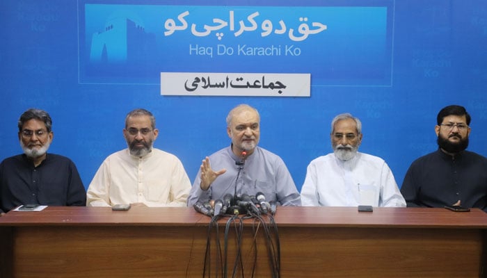 Jamaat-e-Islami (JI) Emir Hafiz Naeemur Rehman (centre) addresses a press conference at the Karachi JI headquarters, Idara Noor-e-Haq, and a party convention on March 1, 2026. —Facebook@HafizNaeemRehman