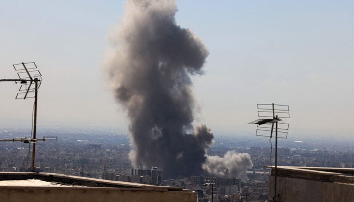 A plume of smoke rises following reported explosions in Tehran on March 1, 2026. — AFP