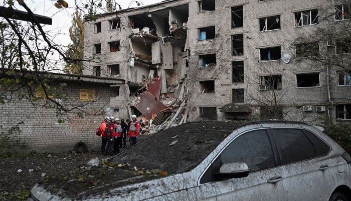 Red Cross employees stand at a site of a dormitory building heavily damaged during an overnight Russian missile and drone strikes, amid Russias attack on Ukraine, in Zaporizhzhia, Ukraine, October 30, 2025.—Reuters