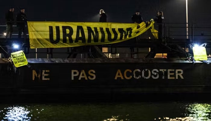 French Police officers remove a banner reading Uranium as Greenpeace activists take part in an operation to block the cargo ship Mikhail Dudin in Dunkirk, northern France, on March 2, 2026. —AFP