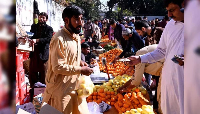 People purchase fruits for Iftar at the Sasta Ramazan bazaar in Islamabad on March 2, 2025. — APP