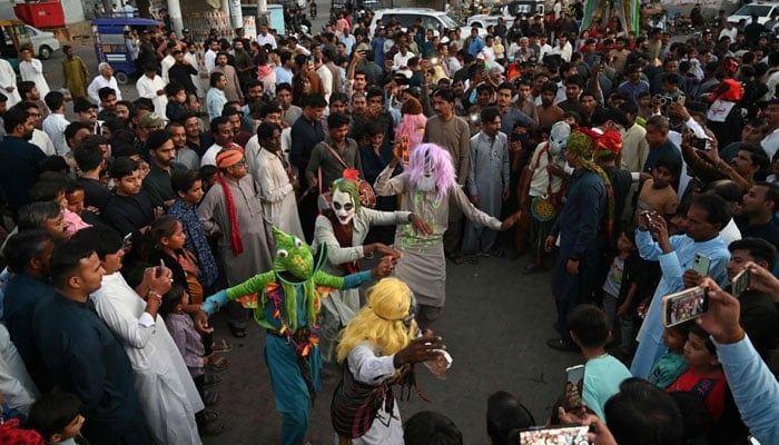 Local Hindu residents celebrate the Hindu festival of Holi in Tharparkar district of the desert town of Mithi, south-eastern Pakistan, on March 13, 2025. — AFP