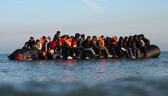 A group of migrants on an inflatable dinghy leave the beach of Petit-Fort-Philippe in northern France in an attempt to cross the English Channel to reach Britain, in Gravelines, near Calais, France, September 27, 2025. — Reuters
