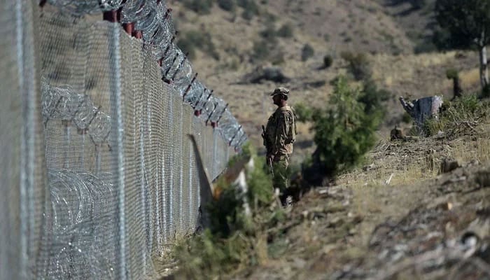 A Pakistani soldier keep vigil next to fenced border fencing along with Afghans Paktika province border in Angoor Adda in South Waziristan on October 18, 2017. — AFP