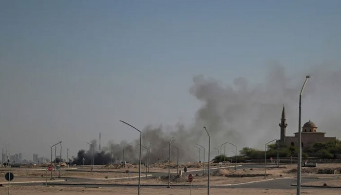 Smoke arises from the US embassy that  was reportedly hit in Kuwait City. —AFP