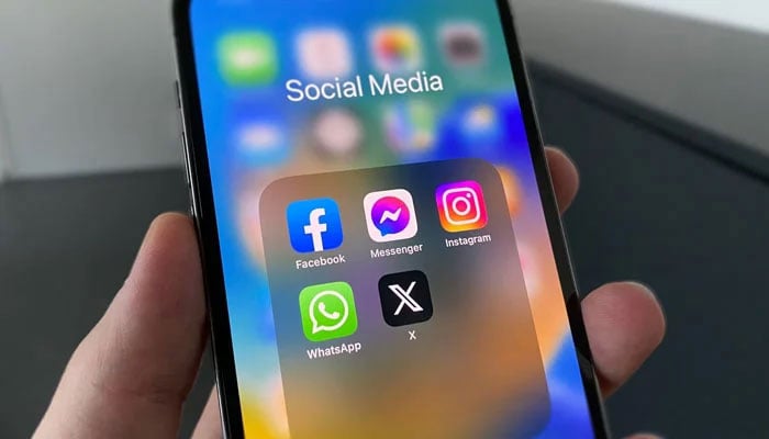 A representational image showing the icons of different social media platforms displayed on a phone screen. — Unsplash/File