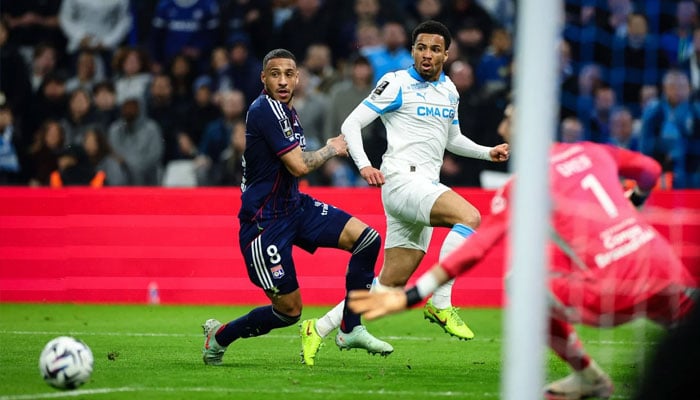 Marseilles English forward Ethan Nwaneri (centre) centers the ball for a teammate before his teams third goal during the French L1 football match between Olympique de Marseille (OM) and Olympique Lyonnais (OL) at the Stade Velodrome in Marseille, southern France. —AFP