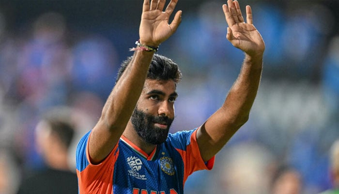 Jasprit Bumrah waves to fans after his crucial 18th over helped India cling to a seven-run T20 World Cup semi-final victory over England. —AFP