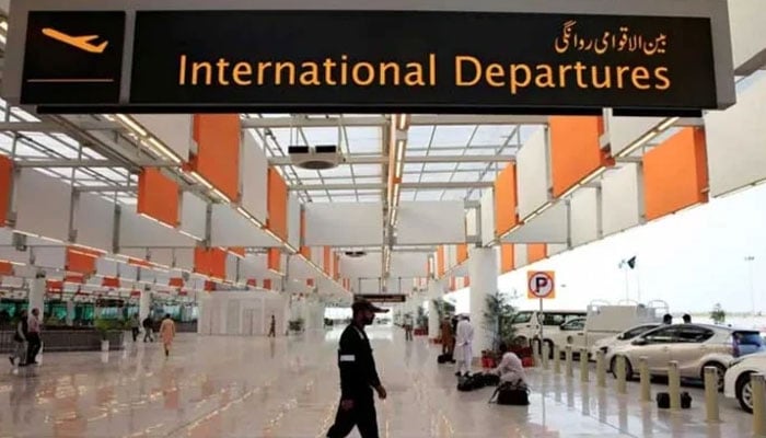 An airport staffer walks past the entrance of international departures at the Islamabad airport. — Reuters/File