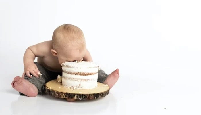 The representational image shows an infant trying to eat a cake.— Pexels/File