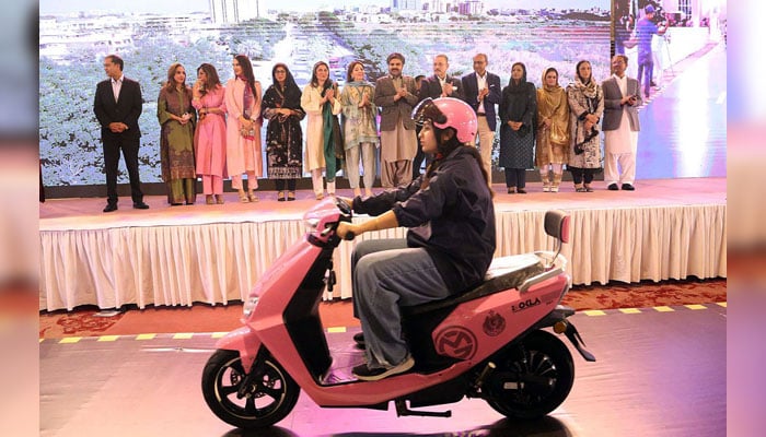 Women receiving pink electric scooters in Karachi