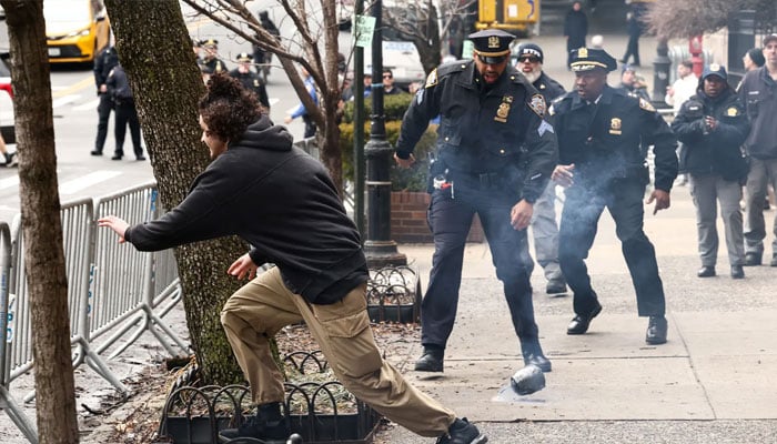 A left-wing activist flees after throwing a homemade explosive device towards police during a protest organized by far-right influencer Jake Lang against alleged “Islamification” and to ask for a “stop of public Muslim prayer” in New York, in front of Gracie Mansion, New York mayor Zohran Mamdani’s official residence, in New York on March 7, 2026. — AFP