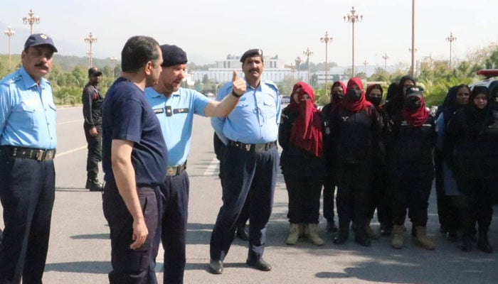Islamabad police personnel standing on the road on March 6, 2026. — Facebook@islamabadpolice