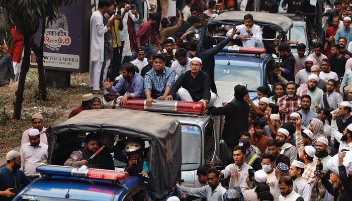 A convoy carrying the body of Sharif Osman Hadi, a student leader, who died after being shot in the head, moves along the crowd after the funeral prayer, in Dhaka, Bangladesh, December 20, 2025. — Reuters