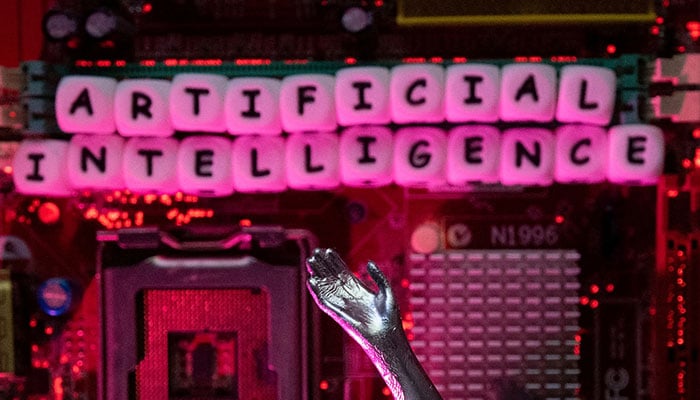 AI (Artificial Intelligence) letters and robot hand are placed on computer motherboard in this illustration taken, June 23, 2023. — Reuters