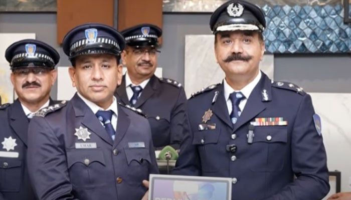 CTO Dr Athar Waheed (right) distributes iPads equipped with the application to circle officers on March 9, 2026. — Screengrab via Facebook@citytraffic.policelhr