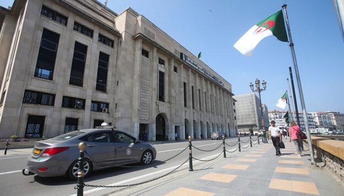 People walk past the building of the lower parliament chamber in Algiers, Algeria September 16, 2020. — Reuters