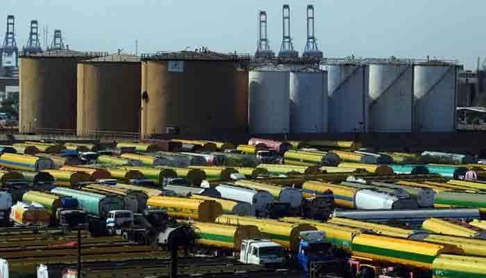 An overview shows tankers parked outside a local oil refinery in Karachi on February 22, 2011. —AFP
