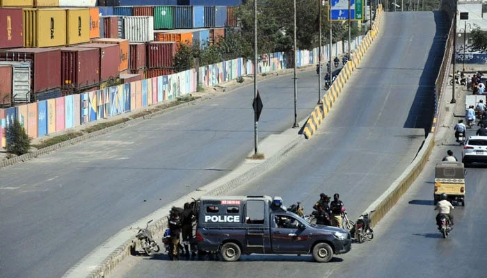 A police mobile is stationed on the road leading to the US Consulate as a security measure in Karachi on March 4, 2026. — Online