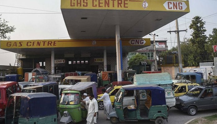 Motorists queue to refill their vehicles with Compressed Natural Gas (CNG) at a CNG station in KP. — AFP/File