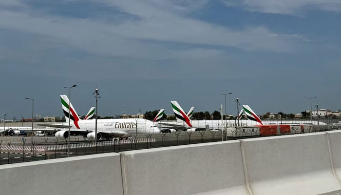 Emirates planes sit on the tarmac of Dubai International Airport (DXB) after two drones came down in the vicinity of the airport, amid the U.S.-Israeli conflict with Iran, in Dubai, United Arab Emirates, March 11, 2026.—Reuters