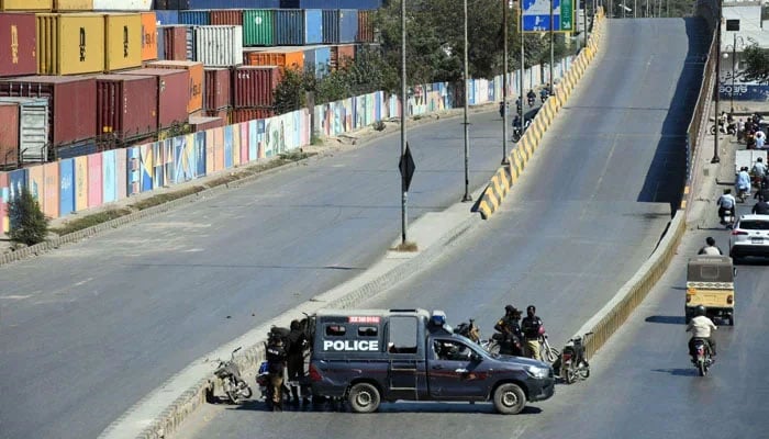A police mobile is stationed on the road leading to the US Consulate as a security measure in Karachi on March 4, 2026. — Online