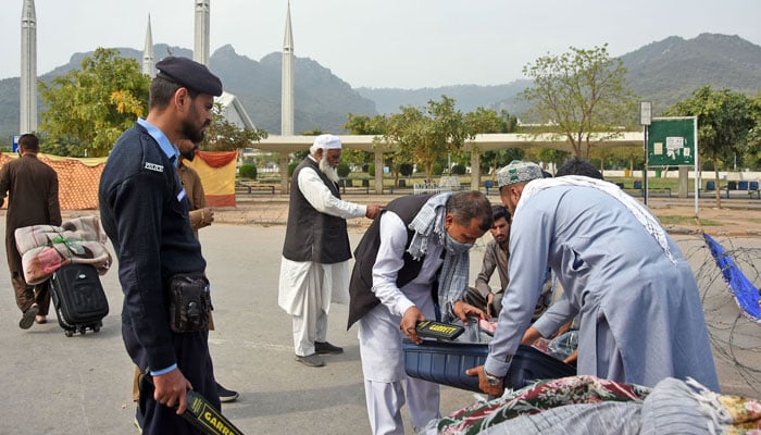 Security personnel check the belongings of people at a police check outside Faisal Mosque in the Federal Capital on March 10, 2026. — Online