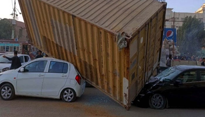 A traffic accident occurred when a speeding bus crashed into a container, causing it to fall onto vehicles travelling on the road, at M.A Jinnah Road in Karachi on March 12, 2026. — PPI