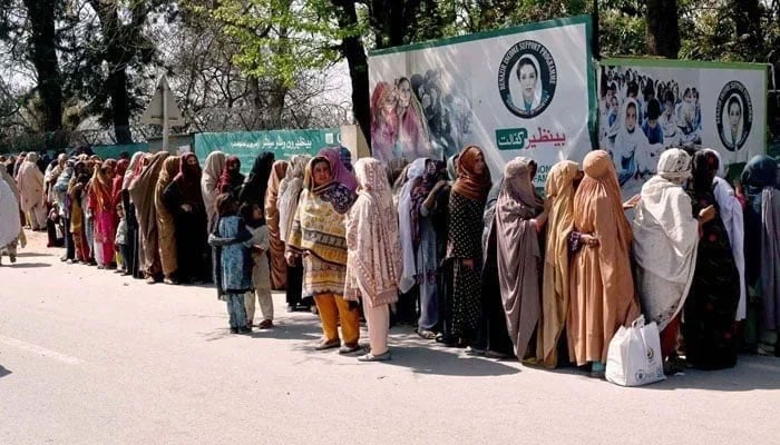 This representational image shows women standing in a queue to draw money from the Benazir Income Support Programme (BISP) beneficiaries outside Benazir One Window Center. — APP/File