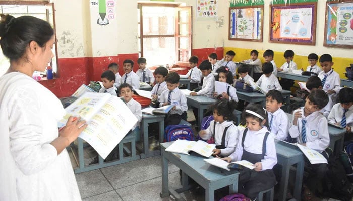 A teacher is reading a lesson to students in her class on World Teachers Day on October 5, 2023. — Online