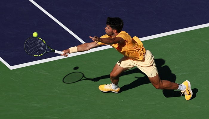 Carlos Alcaraz of Spain plays a backhand against Casper Ruud of Norway in their fourth round match of the BNP Paribas Open at Indian Wells Tennis Garden on March 11, 2026 in Indian Wells, California. — AFP