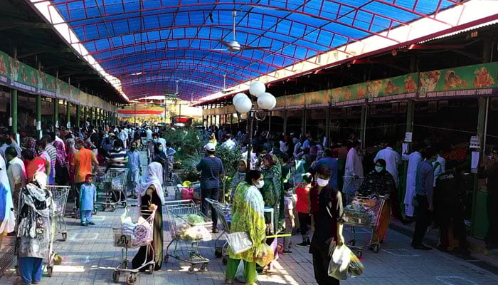 People buying groceries from a Sahulat Bazaar. — APP/File