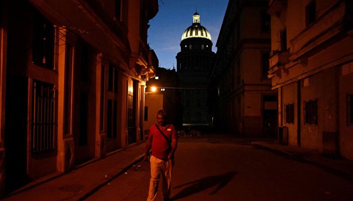 The representational image shows a man walking in Havana on Friday. — Reuters/File