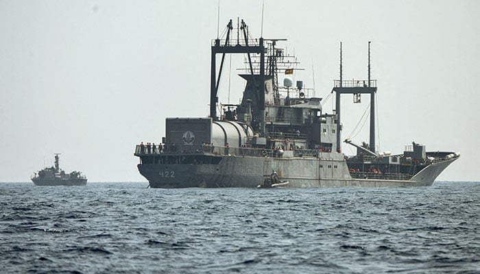 A Sri Lanka Navy vessel approaches an Iranian vessel during a rescue operation, a day after the crew of a distressed Iranian military ship, IRIS Dena were assisted in waters south of Sri Lanka, off the coast of Colombo, Sri Lanka March 5, 2026. — Reuters