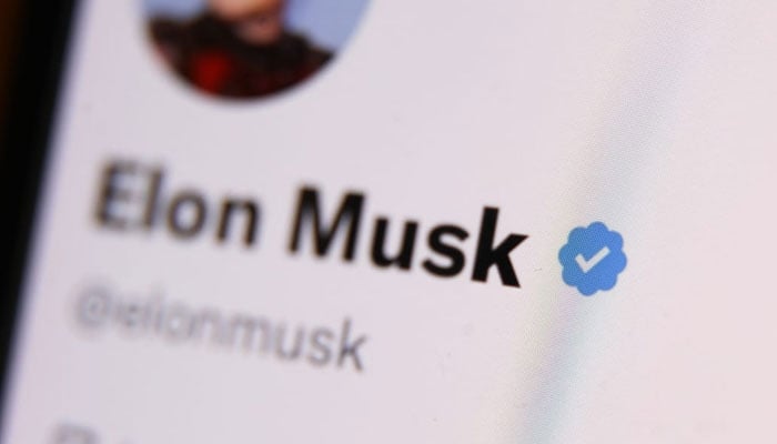 The blue checkmark on Elon Musk account on Twitter is seen displayed on a phone screen. — AFP/File