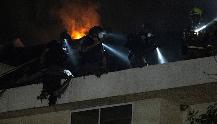 Rescue workers inspect a residential building that was hit following an Iranian missile strike, amid the US-Israeli conflict with Iran, in central Israel March 13, 2026. — Reuters