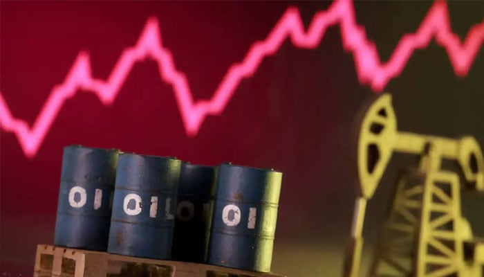 3D-printed oil pump jack and barrels in front of a rising stock graph appear in this illustration. — Reuters/File