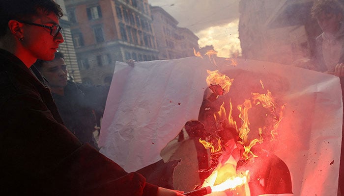 Demonstrators burn a poster depicting US President Donald Trump during a protest supporting the No campaign ahead of Italy’s March 22–23 referendum on judicial reform and criticising the government of Prime Minister Giorgia Meloni’s foreign policies, in Rome, Italy, March 14, 2026.—Reuters