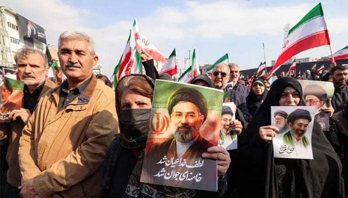 Women hold posters of Iran’s new supreme leader, Ayatollah Mojtaba Khamenei, during a rally held to express support for him, at Tehran’s Enqelab Square.—AFP/File